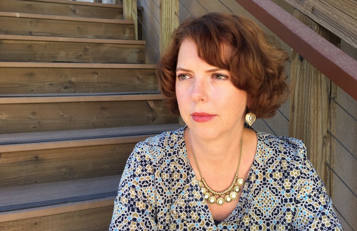 Photography of Susan Valoff sitting on some stairs.