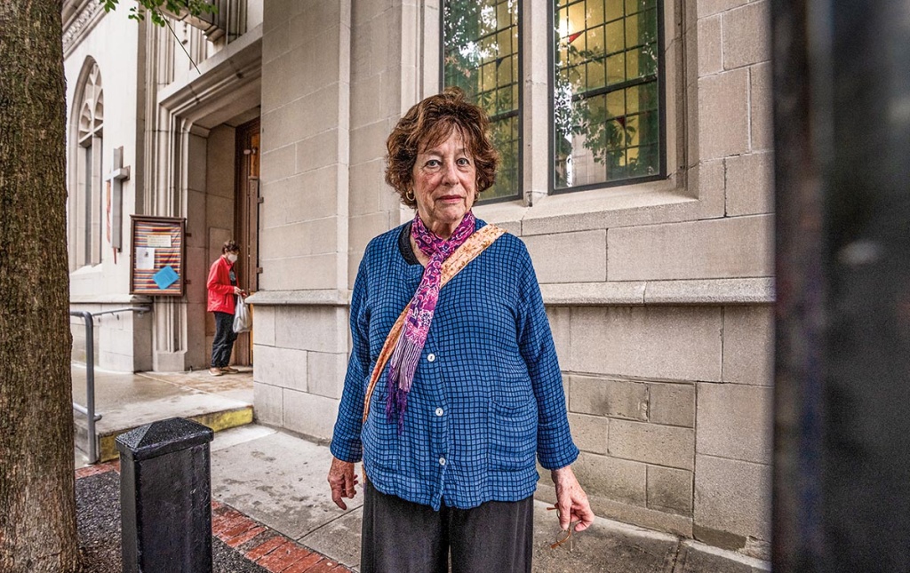 Image of Irene Glasser standing outside the Mathewson Street United Methodist Church in Providence.