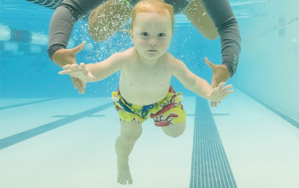 Image of a baby swimming under water in a pool.