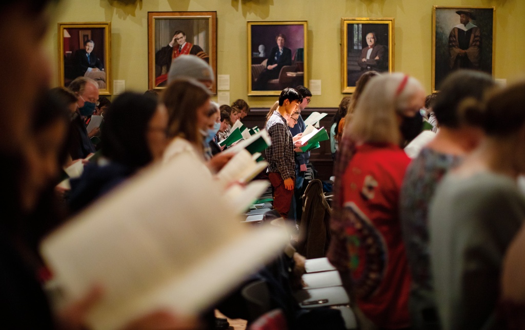 Image of participants singing Latin carols in Sayles Hall