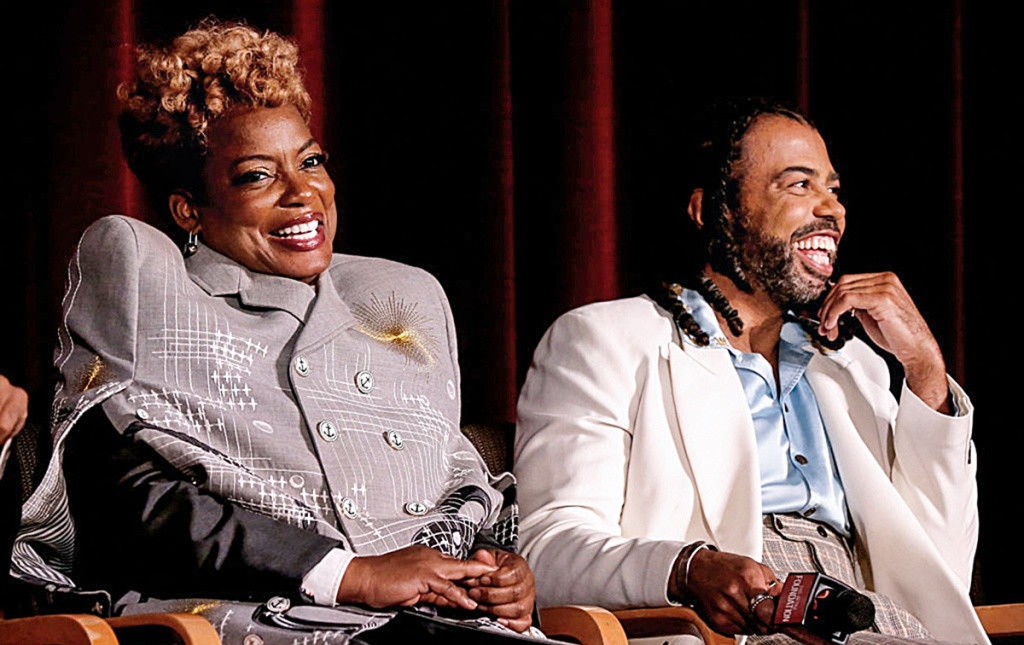 Image of Aunjanue Ellis and Daveed Diggs seated on a stage smiling