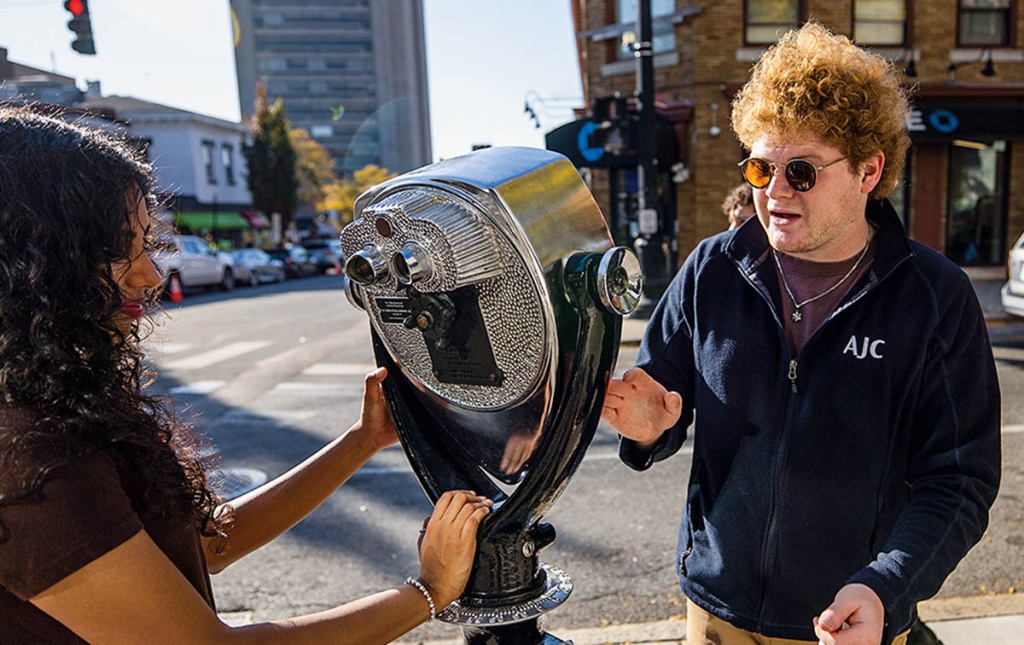 Image of Daniel  Solomon ’26 working on The Blind Urban Subject installation on a Providence street. 