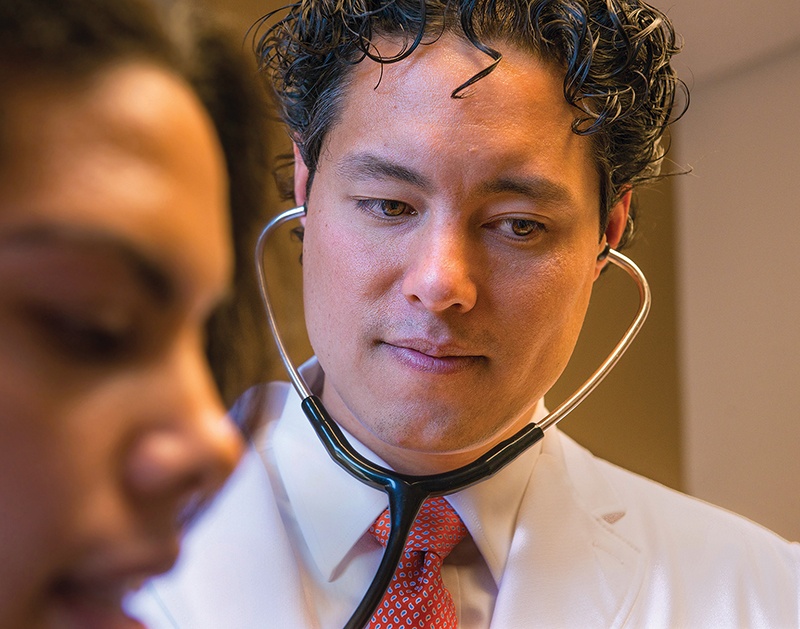 Philip Chan MD checks a patient