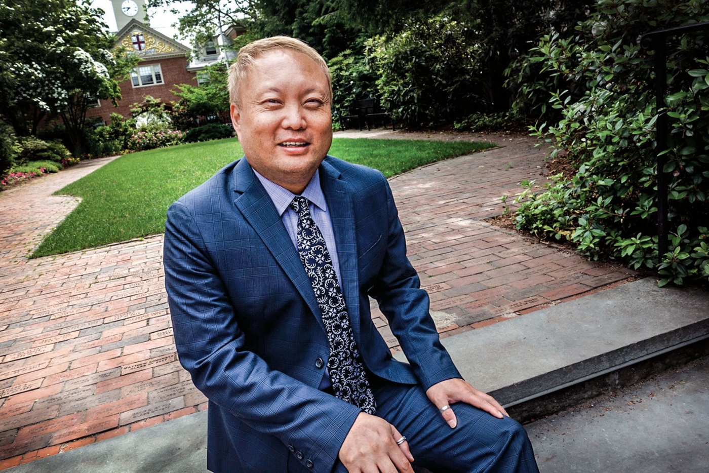 Image of Eric Estes sitting on a bench on campus.