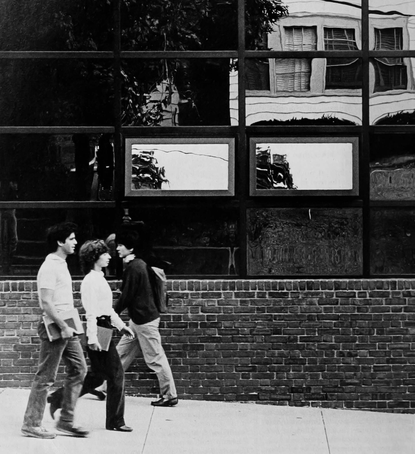 Archival image of students walking by the mirror glass of the 1984 BioMed Center