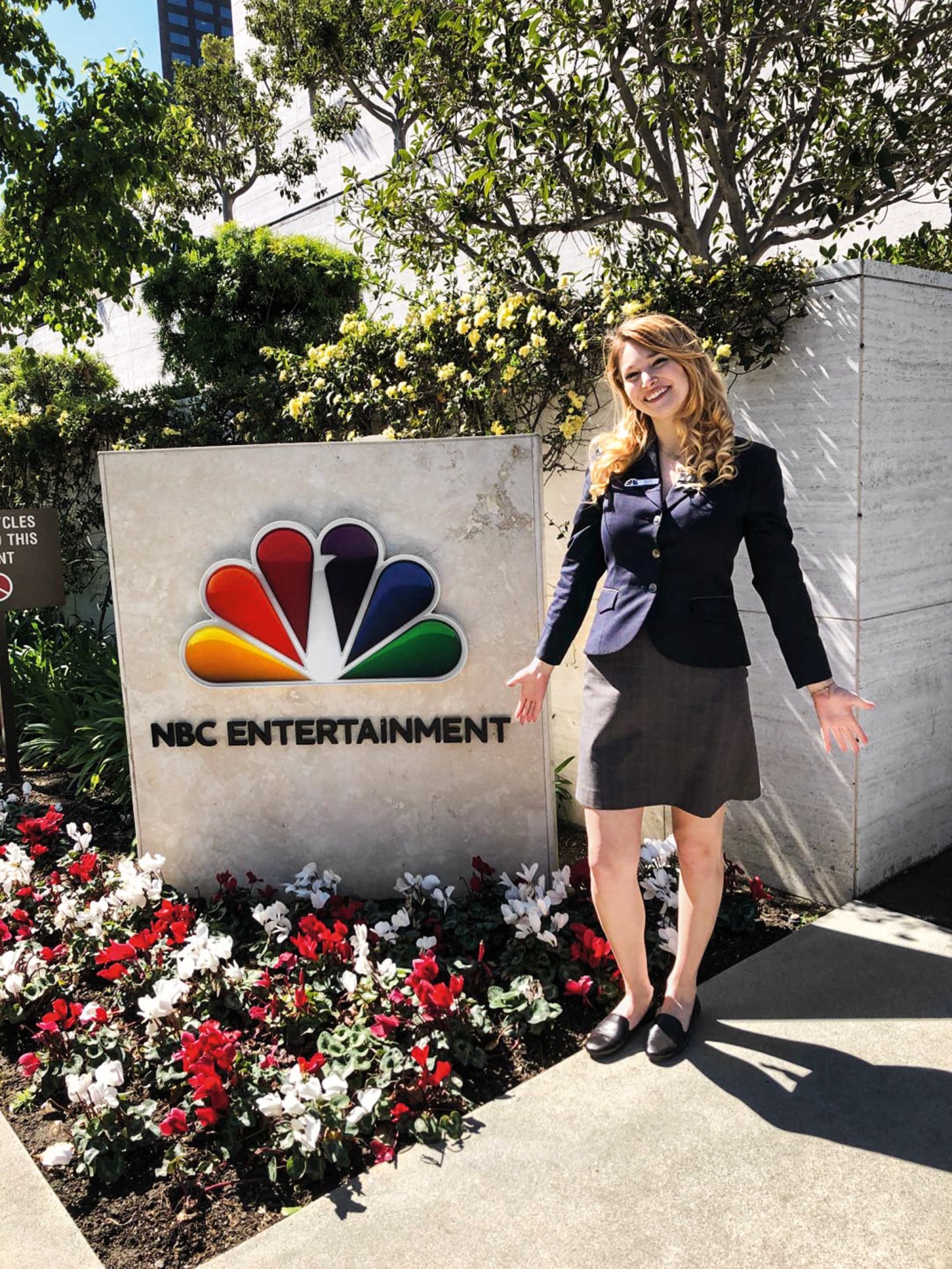 Image of Cathy Campo standing in front of the NBC Studio’s gate