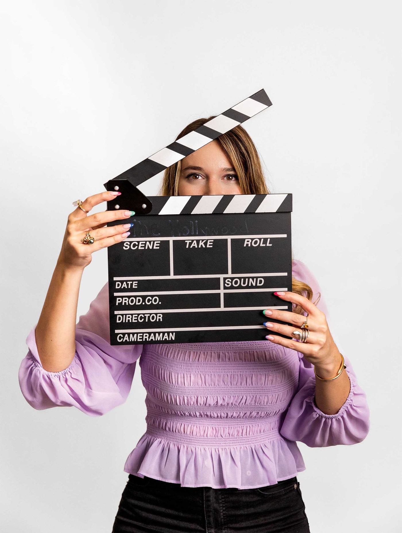 Image of Cathy Campo with a director's clapper