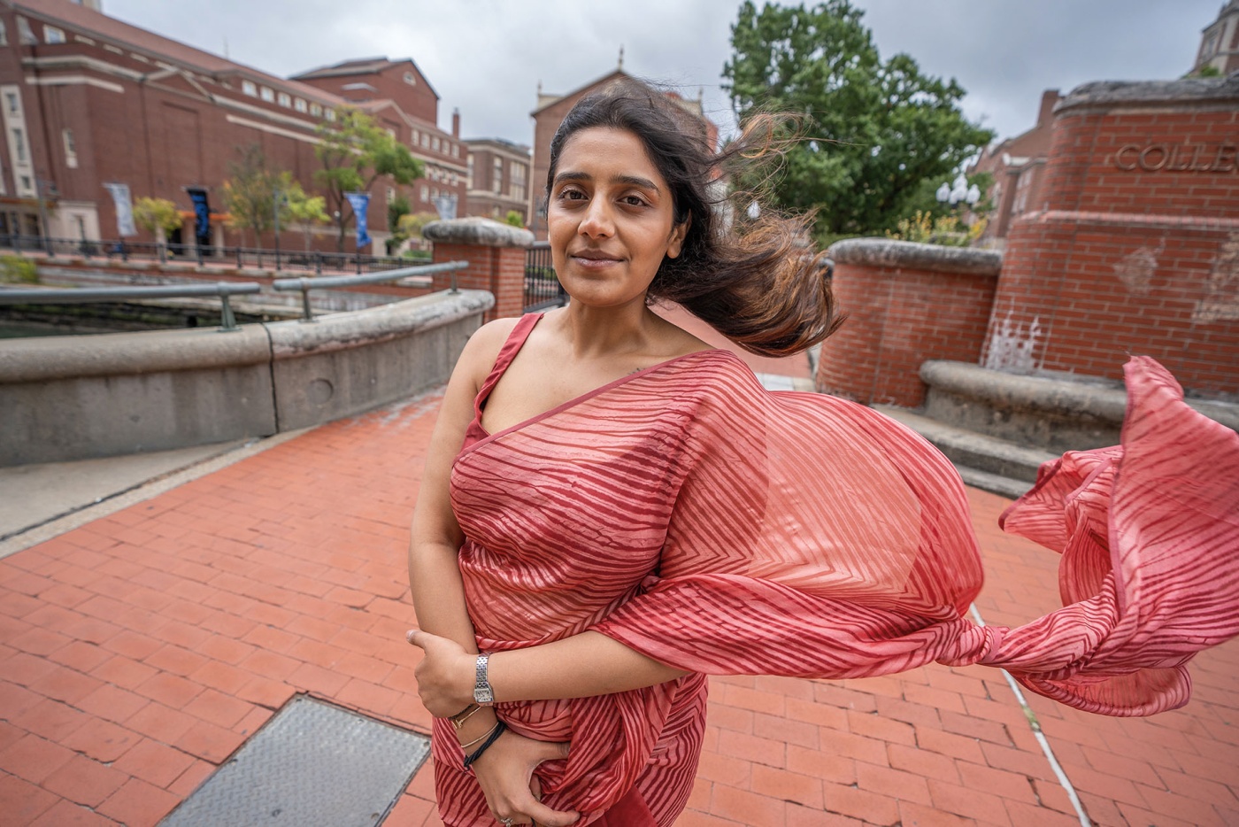 Image of Yukti Agarwal standing on the bridge near RISD in downtown PVD with the wind blowing her dress