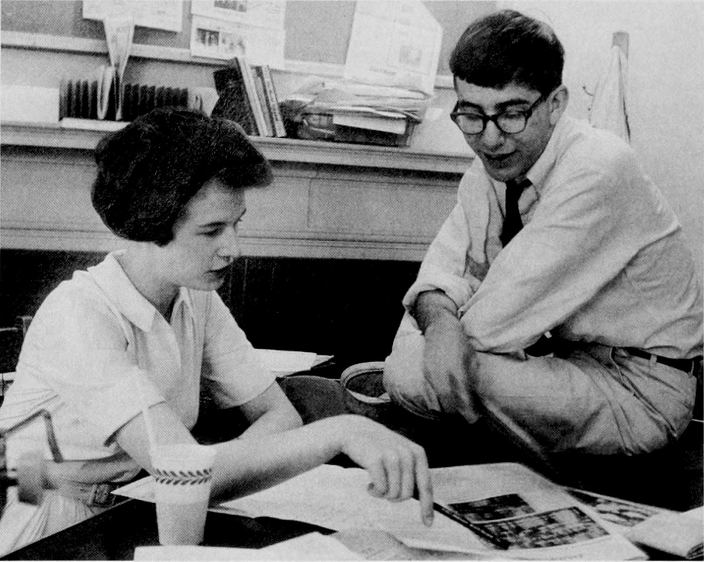 Archival image of the first woman managing editor for the BDH with the editor at a desk