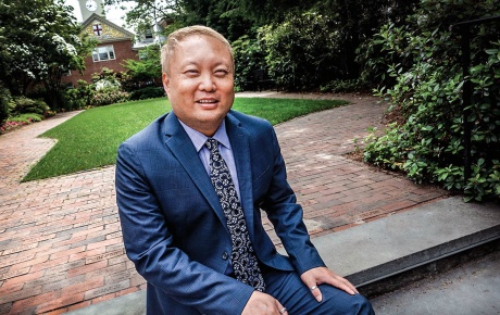 Image of Eric Estes sitting on a bench on campus.