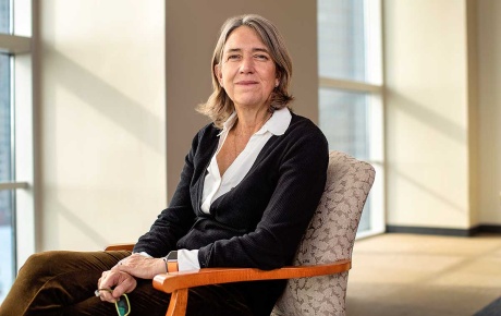 Image of Jane Dietze sitting in a chair by windows.