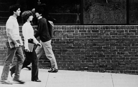 Archival image of students walking by the mirror glass of the 1984 BioMed Center