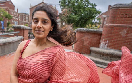 Image of Yukti Agarwal standing on the bridge near RISD in downtown PVD with the wind blowing her dress