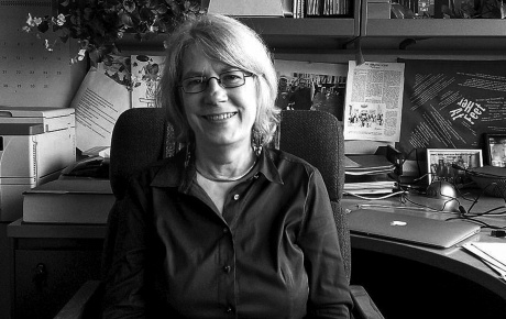 B+W image of Dr. Lundy Braun sitting at her desk